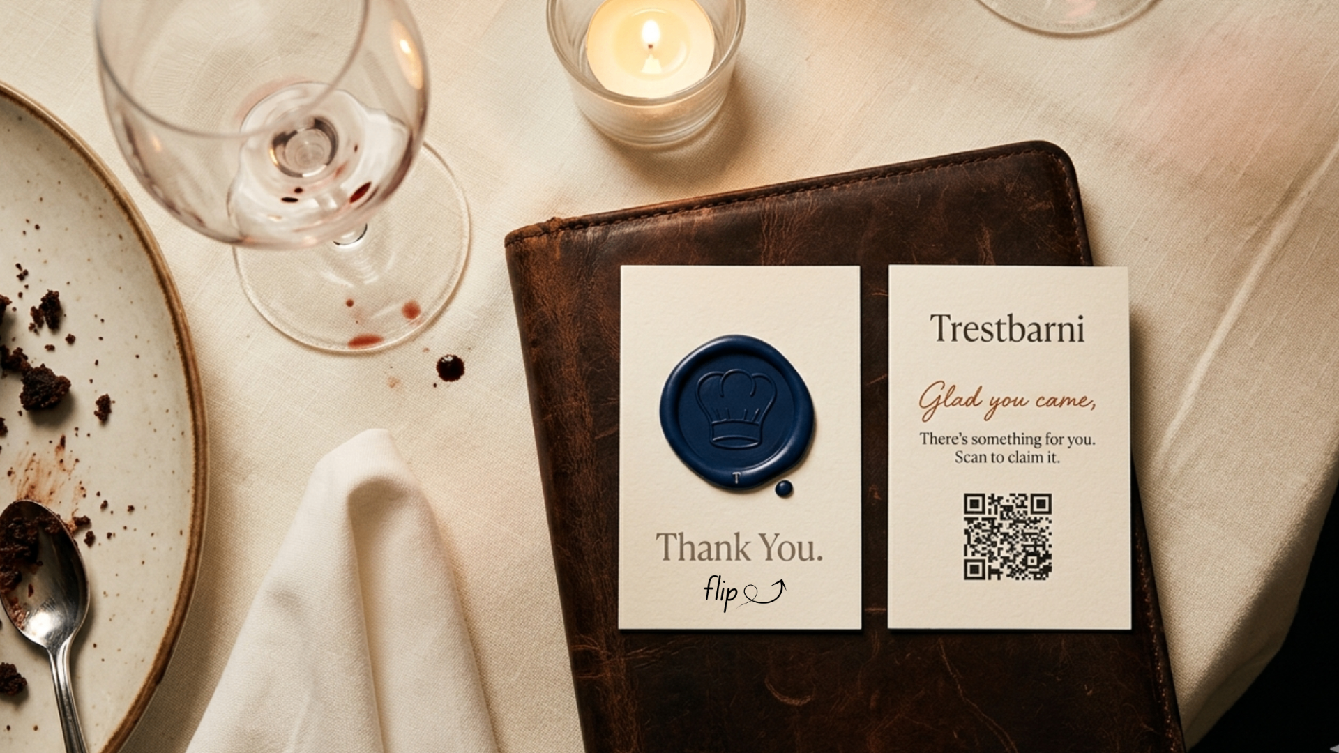Two wax-sealed Tableside thank-you cards resting on a leather check folder at a restaurant table